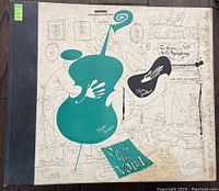Front cover of The Groove Jazz Symphony album showing abstract green and black illustrations of cello and hand, in light tan background, spine showing wear.