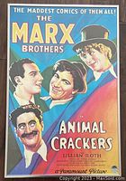 Framed Marx Brothers Animal Crackers movie poster showing colorful illustrations of the four Marx Brothers characters with movie title and credits in retro style.