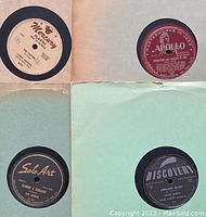 Four 78 RPM records in sleeves: Mercury label in white, Apollo in maroon, Solo Art in black with gold lettering, Discovery in black and gray.