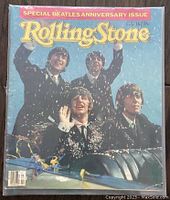 Front cover of a Rolling Stone Beatles Anniversary Issue magazine showing the four Beatles in suits with confetti.