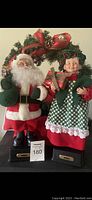 Front view of vintage 16" musical Santa Claus and Mrs Claus figurines standing side by side on bases labeled "NOEL"