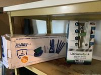 Shelf with boxed Blue Wave cordless Pool Blaster Fusion handheld cleaner and Wahl Lithium Ion All-in-One trimmer, both unopened.