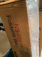 Photo of the box with the Marcy NS-654 model number and foldable bike branding visible, showing condition and packaging.