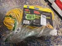 Plastic wrapped yellow extension cord with black and yellow label showing Bergen Industries brand and product details.