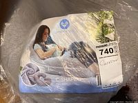 Packaged PharMeDoc C-Shape full body comfort cushion with label showing a woman using the pillow for body support.