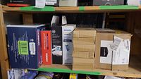 Shelf view showing multiple boxed items including Philips Sonicare toothbrushes, Arris ice wrap box, military brush sets.