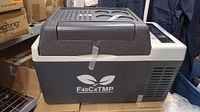 Front side view of grey and white portable refrigerator showing F40C4TMP logo and overall condition