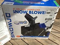Front of opened Snow Joe box showing “48V Max Cordless Snow Blower” branding