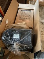 Box containing the inline tube fan and filter with specification details printed on the box.