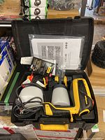 Top view of Wagner paint sprayer and accessories inside black hard plastic case