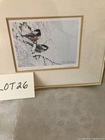 Framed print of two birds on snow-covered branches, showing full artwork and frame.