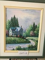 Framed oil painting showing a country house, driveway, and greenery in a peaceful landscape setting, signed by artist K. Bruce.