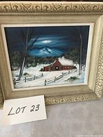 Front view of original oil painting in an ornate frame depicting snowy winter scene with house and moonlit mountains.