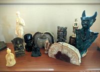 Overview photo of assorted figurines and geode bookends on wooden surface