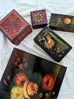 Top view of five closed decorative jewelry boxes on white background