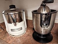Both juice extractors, Waring Kitchen Classics on left and Eurolux on right, side by side on kitchen counter.