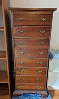 Full front view of the 8-drawer dresser, showing vintage wooden texture and brass handles.
