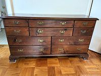 Front view of the 10 drawer vintage wooden dresser showing overall condition and design.