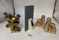 Three pairs of bookends displayed: Rodin The Thinker bronze cast metal, Andrea by Sadek resin cherubs, and white marble. Shows overall lot.