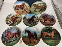 Eight Champion Thoroughbred collector plates arranged on a white surface, showing detailed horse illustrations.