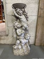 Full view of the cherub bird bath statue showing three cherubs stacked and supporting the basin.