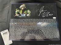 Full front view of signed photo in protective plastic sleeve
