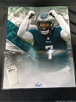 Full view of signed 16x20 photo in protective sleeve