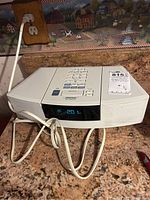 Front view of ivory white unit with digital display and power cord