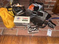 Overall lot showing Canon AE-1 box, foreign converter kit, Instamatic 414, Bell & Howell, digital clock, lights and other items