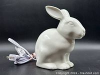 White ceramic bunny rabbit light facing right showing details and electrical cord.