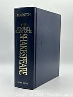 Photo showing the front spine and cover edge of the large blue hardcover book with gold embossed title 'The Complete Illustrated Shakespeare' edited by Howard Staunton, published by Park Lane.