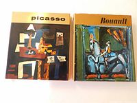 Front view of two vintage art books with dust jackets, featuring Picasso and Rouault prints