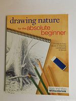 Front cover of the book showing the title, a detailed pencil drawing of a tree trunk, and colored pencils and eraser illustrations.