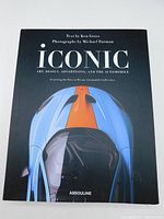 Front cover of the large coffee table book showing title and a stylized image of a blue car with an orange stripe.