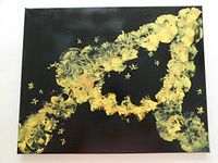 Front view of the original abstract acrylic painting 'Midnight Gold' showing black background with textured gold and yellow painted floral pattern.