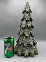 Photo showing full snowy tree decor next to 7up can for size reference, highlighting height about 15.5 inches.