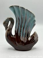Photo showing front angle of vintage drip glaze swan vase in blue and brown colors with glossy finish and wing forming vase opening