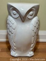 Front view of white ceramic owl side table showing detailed wings and face features.