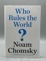 Front cover of 'Who Rules the World?' showing title, author Noam Chomsky, and a question mark with an Earth icon.