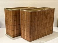 Two rectangular wicker baskets with a tan bamboo-style woven outer surface and inner fabric lining, standing side by side.