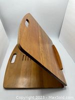 Side angled view showing wood finish and handle cutouts on base and support panels.