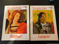 Two vintage art books titled 'Raphael' and 'Gauguin' from 'The Great Artists' series, showing front covers with famous paintings.