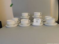 Set of 10 cups and 10 saucers arranged in two rows showing the entire lot
