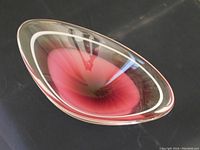 Top angled view showing the clear glass bowl with pink gradient interior and smooth curved design.