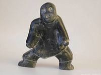 Full view of the soapstone sculpture showing figure stance and general shape.