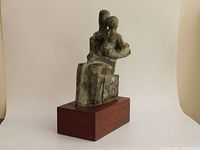 Front-left perspective of the sculpture on white backdrop showing form and base