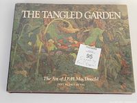 Front cover of the art book 'The Tangled Garden: The Art of J.E.H. MacDonald' with a sticker noting it is signed by Paul Duval.
