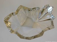 Top-down view of clear faceted glass ice vase with irregular wavy rim