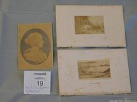 Three William Notman photos laid out on grey surface, showing the profile Queen Victoria image and two sepia landscape photos on aged boards.