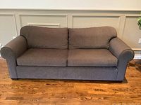 Front view showing full three-seat design against wainscoting